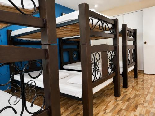 a group of bunk beds in a room at Hostal Avanza in Cali