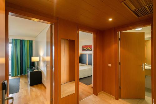 a room with a door leading to a bedroom at Antillia Hotel in Ponta Delgada