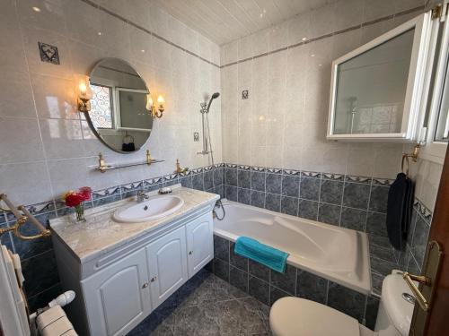 a bathroom with a sink and a tub and a toilet at La Catalane in Perpignan