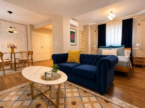 a living room with a blue couch and a table at Casa Rosetta Boutique in Xàtiva