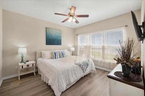 a bedroom with a bed and a ceiling fan at Lakefront Paradise with Stunning Views! in Corsicana