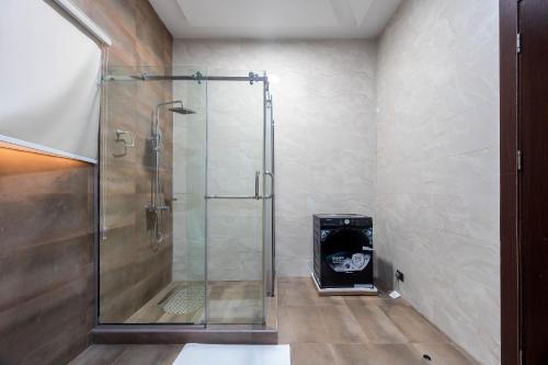 a shower in a bathroom with a glass shower stall at Yaniv Apartments Oniru in Lagos