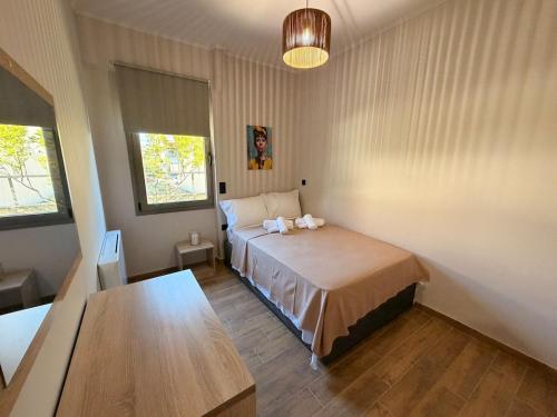 a bedroom with a bed and a table in it at Casa Marino in Chalkida
