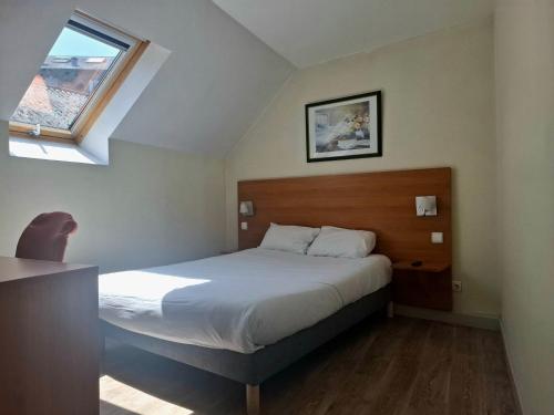 a bedroom with a bed and a window at Hôtel de Paris - Dijon Centre Gare in Dijon