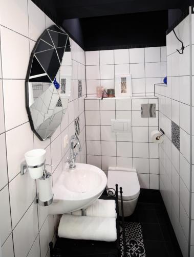 a white bathroom with a sink and a toilet at Alt Wien in Vienna