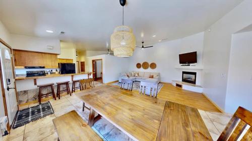 a large living room with a table and a kitchen at Canyon Portal #469 in Moab