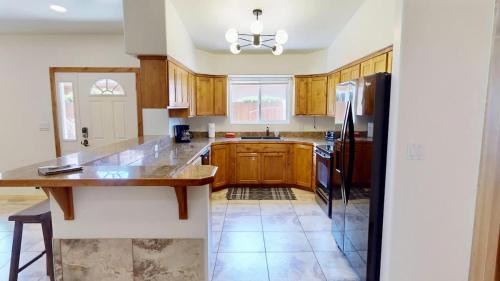 a kitchen with wooden cabinets and a refrigerator at Canyon Portal #469 in Moab