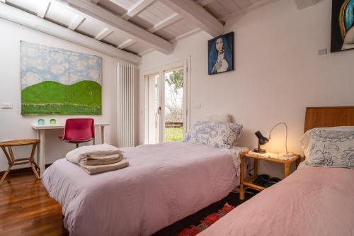 a bedroom with two beds and a window at Granducato di Monteballante in Pesaro