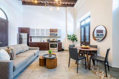 a living room with a couch and a table at Casa Las Ruinas Boutique Hotel in San Juan
