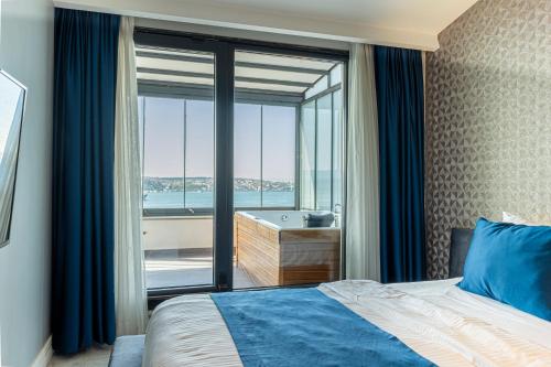 a bedroom with a bed and a window with a tub at Elite World Homes Istanbul Bosphorus in Istanbul