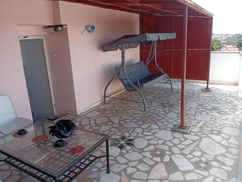 a room with a chair and a glass table at Apartament MaTei in Timişoara
