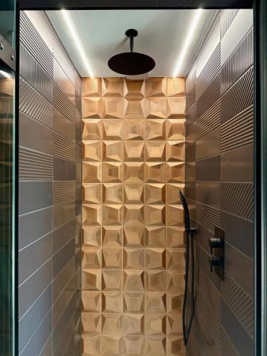 a bathroom with a shower with brown tiles at Uno By The Sea - Boutique Hotel in St Ives