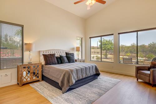 a bedroom with a bed and a couch and windows at Fire Pit & Large Yard! Luxury Anthem Escape in Anthem