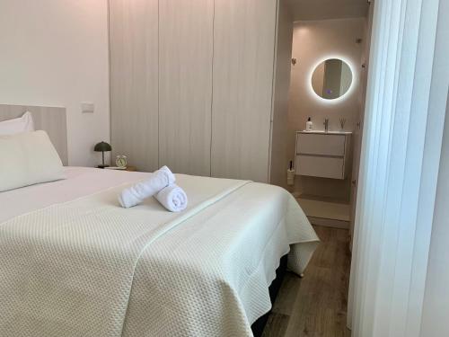 a bedroom with a bed with two towels on it at Casa Miralago - Gerês in Admeus