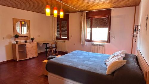 a bedroom with a bed and a desk and window at Apartamento Uno in Guadalaviar