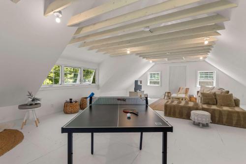 a living room with a table and a couch at Featured in Cape Cod Life Magazine in Barnstable
