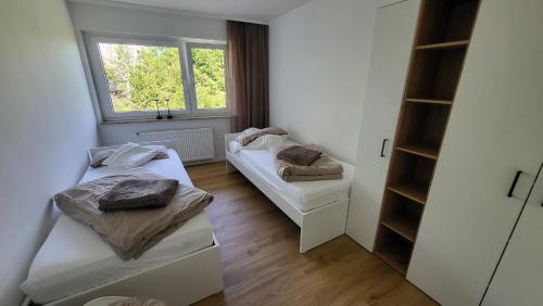 a room with two beds and a window at FeWo Panoramablick Geislingen in Geislingen an der Steige