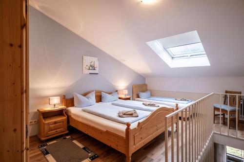 a bedroom with a large bed with a skylight at Bergschlössl - Massionettwohnung 16 in Oberaudorf