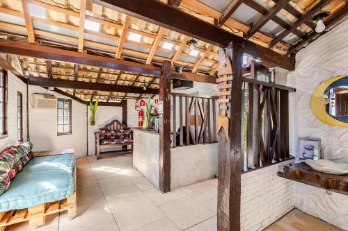a living room with a couch and a table at Pousada Lua Chalés in Maresias