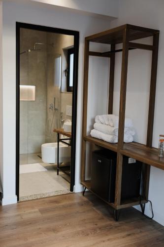 a bathroom with a walk in shower and a glass door at Albulena Hotel & Camping in Shkodër