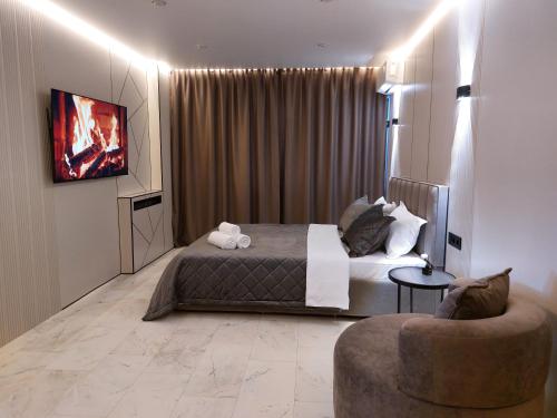 a hotel room with a bed and a couch at Премиум квартира в современном стиле in Līsakovsk