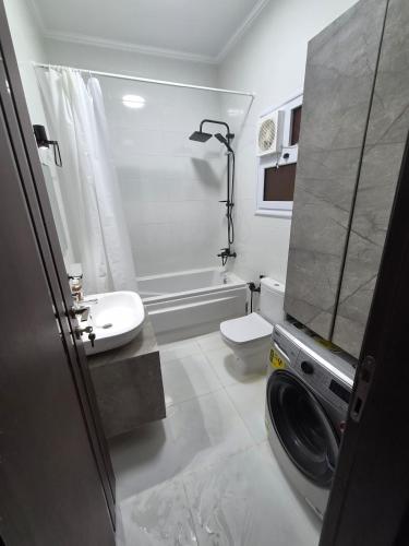 a bathroom with a sink and a toilet and a shower at Royal Green Haven 3BR Apartment near Airport Obour in Obour