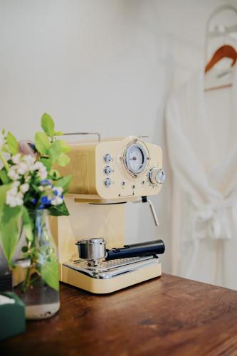 a camera sitting on a table with a vase of flowers at The Ram Inn in Lewes