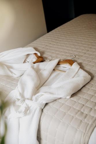 a pair of white clothes sitting on a bed at The Ram Inn in Lewes