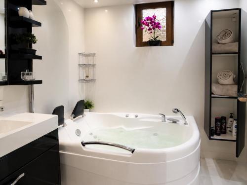 a white bathroom with a sink and a tub at Azur House2 in Cluj-Napoca