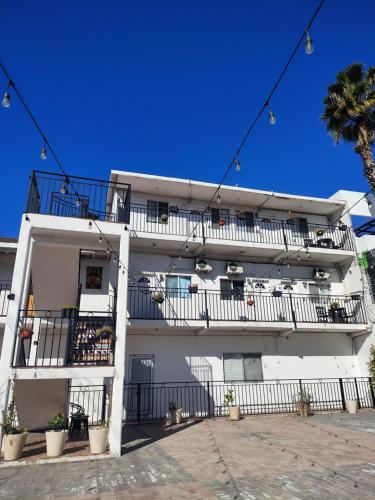 a white apartment building with balconies on it at Villa Angel in Tijuana