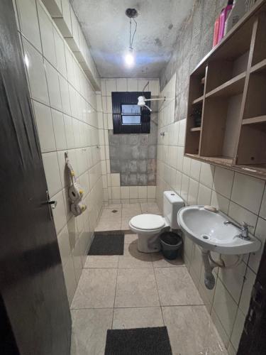 a bathroom with a toilet and a sink at Beco 6 in Petrópolis