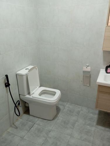 a bathroom with a toilet and a sink at Casa Marabella C3 in Diani Beach