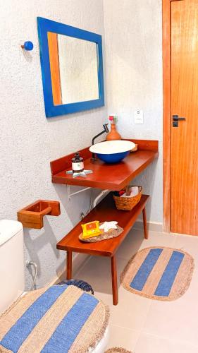 a bathroom with a sink on a wooden table at Recanto Manoah MAR in Caraíva