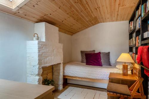 a small room with a bed and a fireplace at 3 Bed in Eype oc-e34183 in West Bay