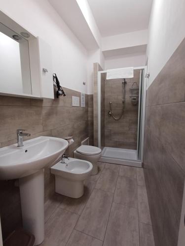a bathroom with a sink and a toilet and a shower at Studio 23 in Partinico