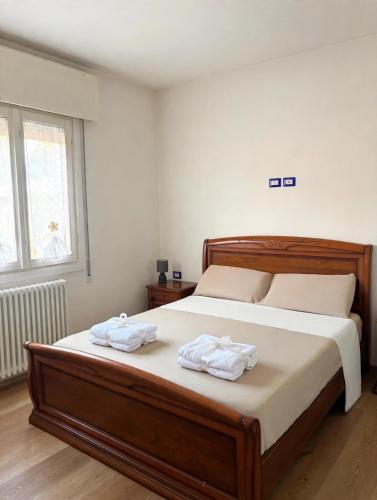 a bedroom with a bed with two towels on it at Casa Vecellio in Noale