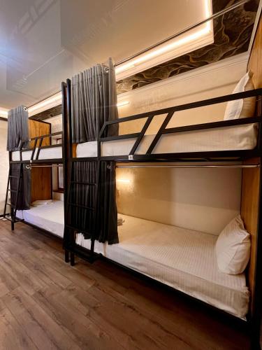 a group of bunk beds in a room at AL-BUKHARI Boutique Hostel in Bukhara