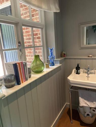 a bathroom with a sink and a window at Riverside Cottage Sleeps 8 with Parking in Marlborough
