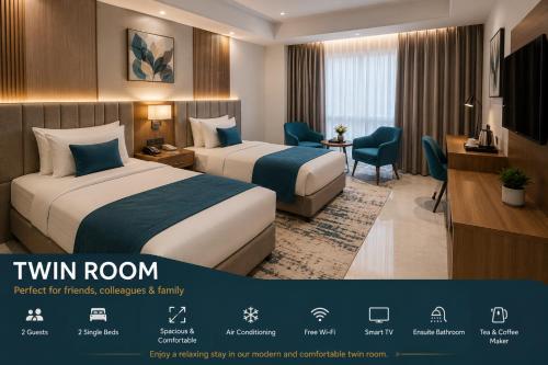a hotel room with two beds and a desk at EZ Homes in Abu Dhabi