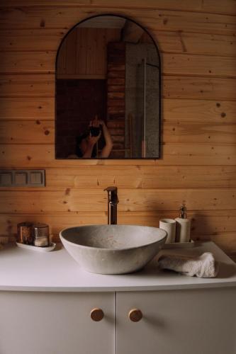 a person taking a picture of a sink in a bathroom at Stodoła Baryczy in Postolin