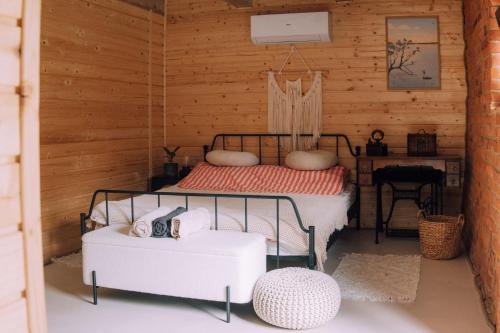 a bedroom with a bed in a wooden wall at Stodoła Baryczy in Postolin