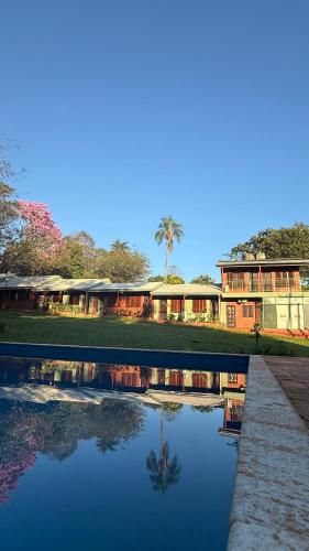 a reflection of a building in a pool of water at Iguazú Garden Lodge in Puerto Iguazú