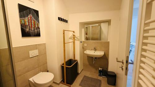 a bathroom with a toilet and a sink at Cozy Corner - Passau in Passau