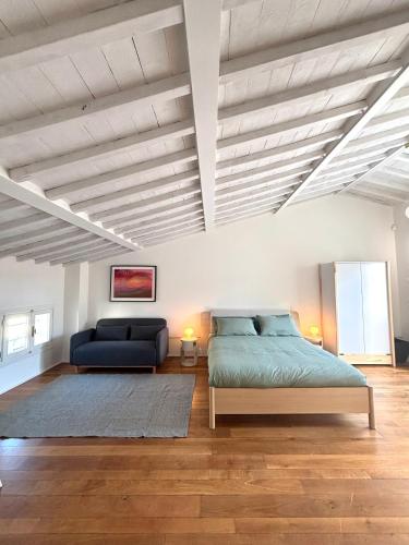a bedroom with a bed and a couch at Casa Lucibell in Prato