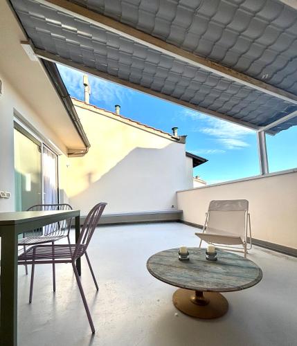 a living room with a table and chairs and a table and chairs at Casa Lucibell in Prato