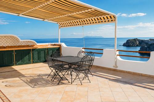 a table and chairs on a patio with the ocean at Maridea - La Terrazza in Ponza