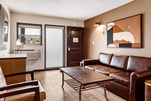 a living room with a couch and a table at LUXX Taos Motor Lodge in Taos