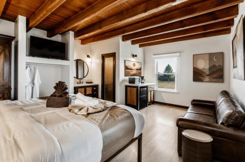 a bedroom with a large bed and a couch at LUXX Taos Motor Lodge in Taos