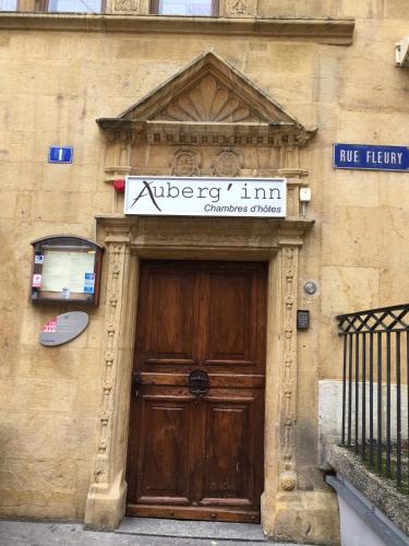a building with a wooden door with a sign above it at Aux chambres du Banneret in Neuchâtel