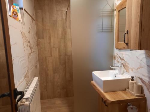 a bathroom with a white sink and a mirror at Костовският хан in Chepelare